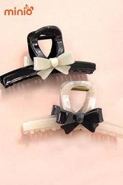 Kẹp càng cua nơ đen kem UX