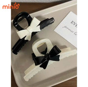 Kẹp càng cua nơ đen kem UX